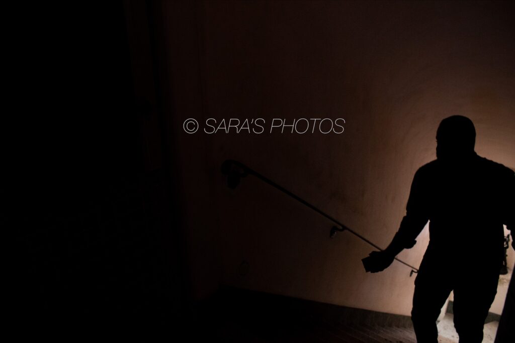 A person holding onto a pole in the dark